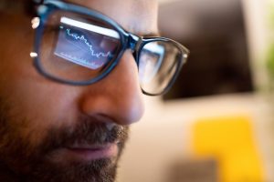 money-manager-stock-chart-reflection-glasses-laptop-buy-sell-getty.jpg